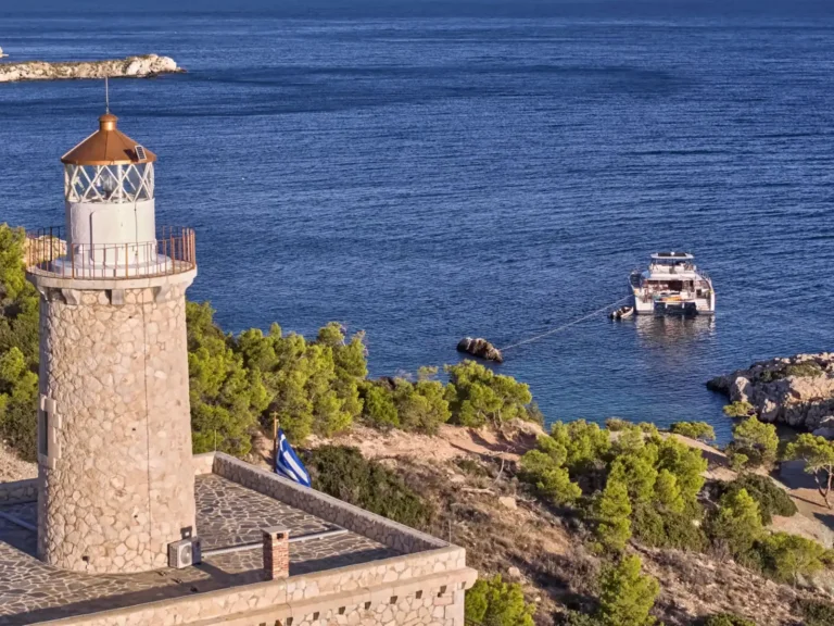 Power 67 MAJESTY OF GREECE – At anchor below a lighthouse